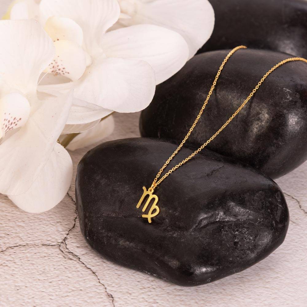 18k yellow gold Virgo zodiac sign necklaces showcase on rock