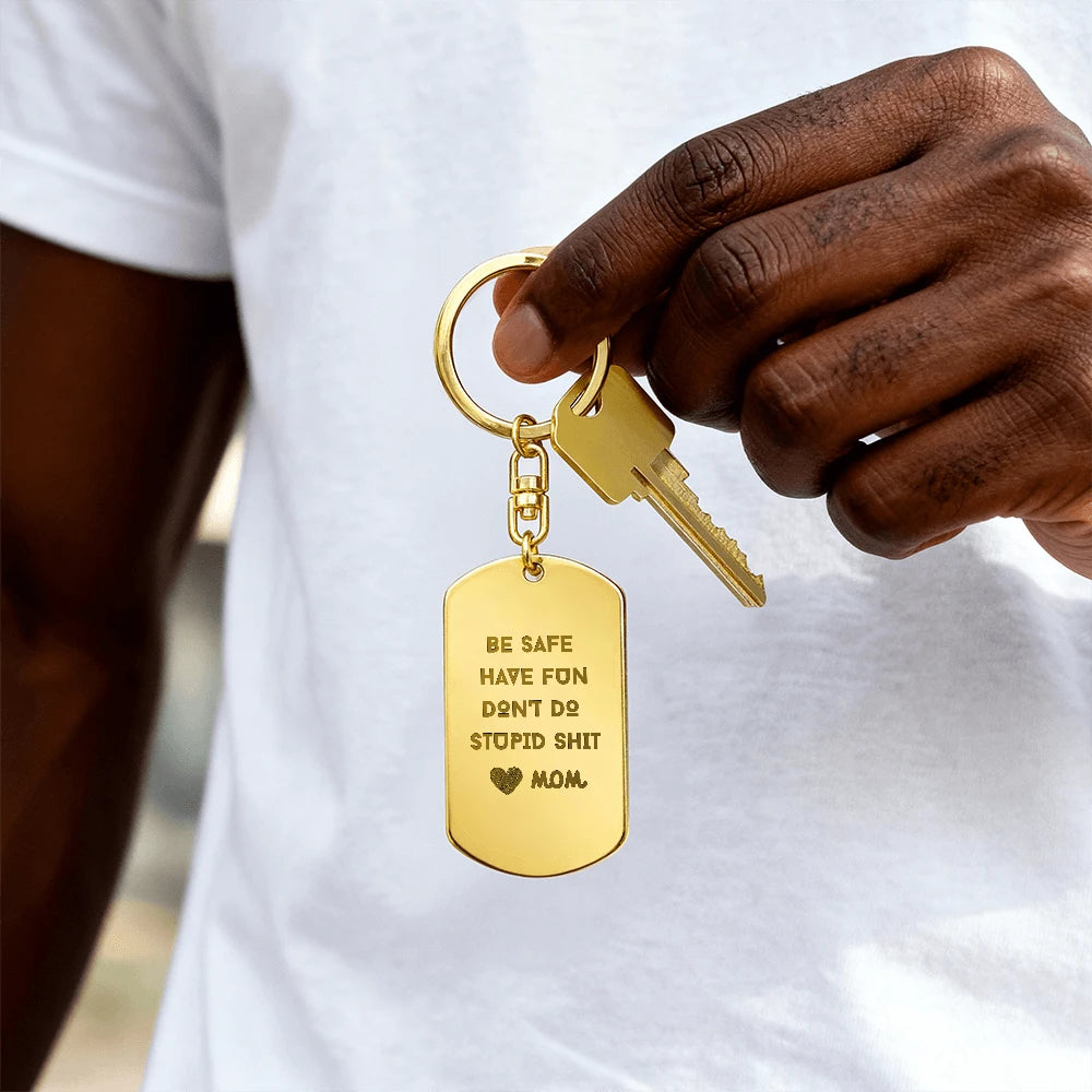 18k yellow gold engraved dog tag keychain for children be safe showcase in hand