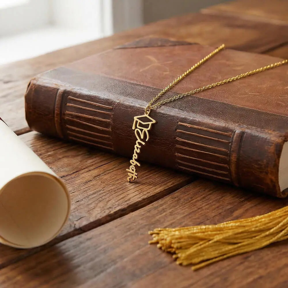 18k yellow gold personalized graduation cap necklace showcase on table