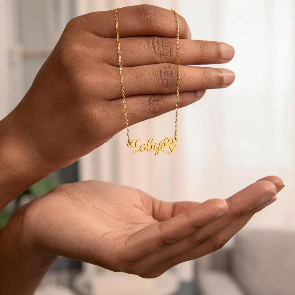 18k yellow gold personalized paw print name necklace for pet lover showcase in hand